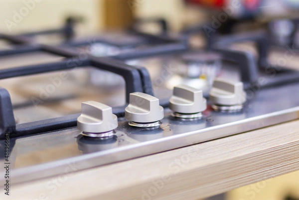 Obraz Switches and burner of a gas stove close-up on a blurred background