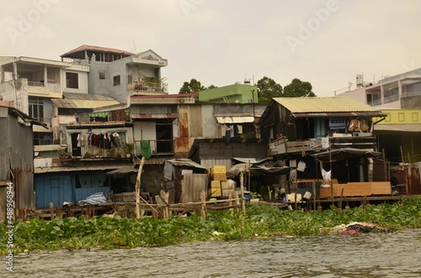 Fototapeta A floating house while sailing the Mekong river delta. Different Vietnam images, streets, markets, rivers.