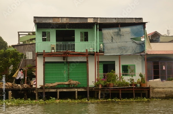 Fototapeta A floating house while sailing the Mekong river delta. Different Vietnam images, streets, markets, rivers.