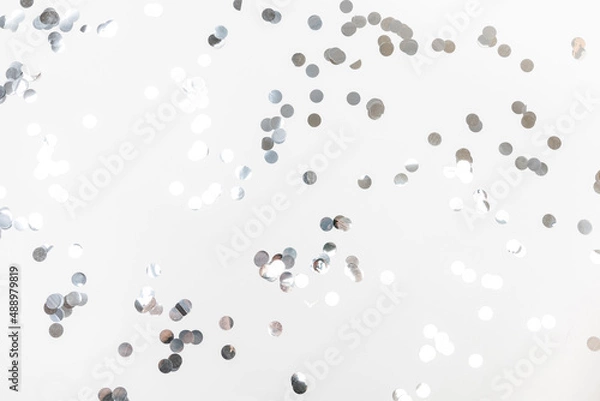 Fototapeta round silver confetti on white background flat lay text place .