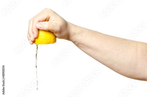 Fototapeta Hand squeezing lemon