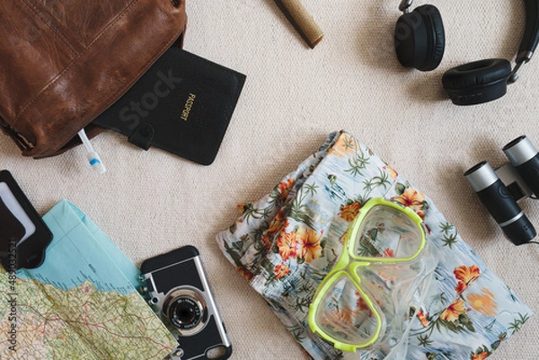 Fototapeta Flat lay style overhead shot of vacation or travel items. Things to pack for a trip or holiday. Cool vintage style with copy space available