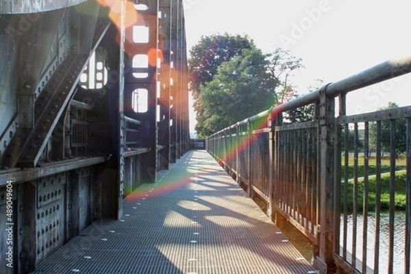 Obraz Path over river next to railway bridge