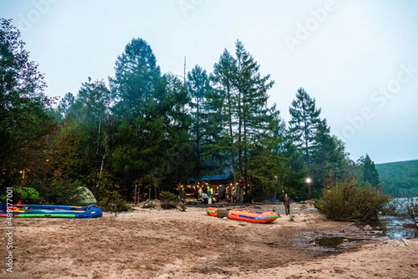 Obraz tourists in a forest camp on the river bank against the background of the forest