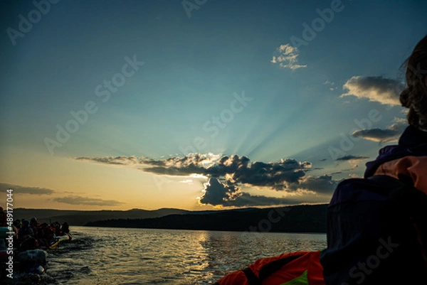 Obraz sunset on the background of mountains the rays of the sun break through the beautiful clouds