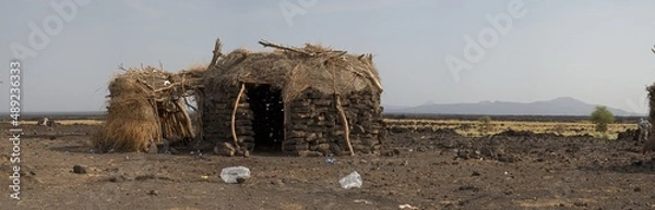 Fototapeta Landscape panorama view of traditional houses in front of Erta Ale Volcano in the remote regions of Ethiopia.