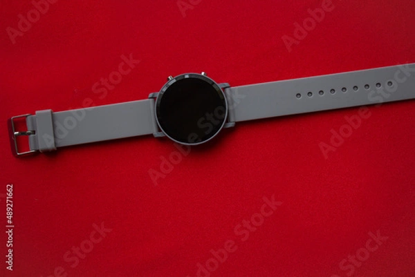 Fototapeta Time to travel. Sun lounger, umbrella and alarm clock on a red background.