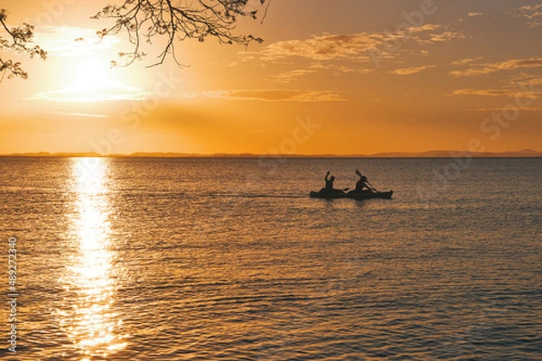 Obraz Silhouette of people kayaking at sunset on the lake at Ometepe island, Nicaragua