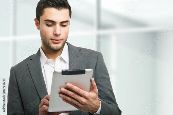 Fototapeta Man using his tablet computer