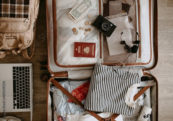 Obraz open suitcase with clothes and things