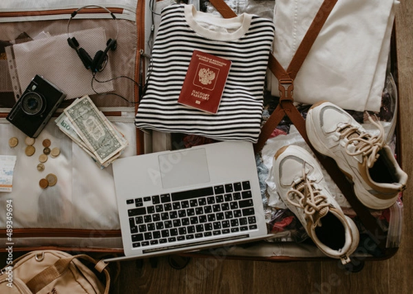 Obraz open suitcase with clothes and things