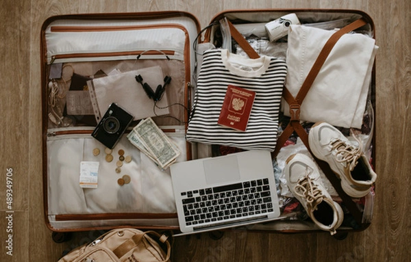 Obraz open suitcase with clothes and things