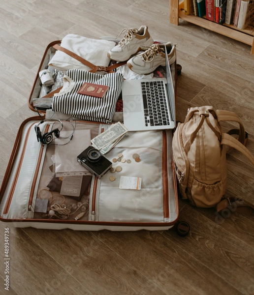 Obraz open suitcase with clothes and things