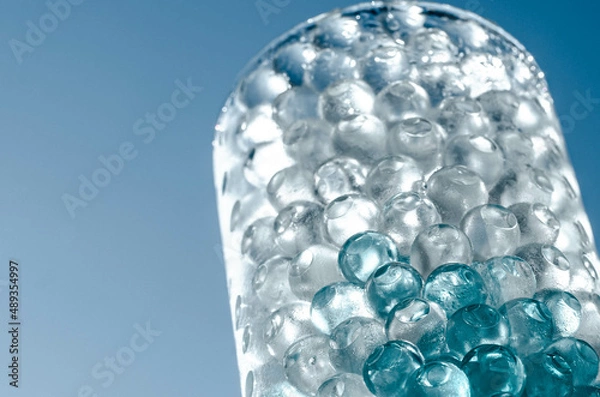 Obraz Hydrogel balls in a glass vase. Hydrogel as an art object or background for a computer desktop. Hydrogel close-up.