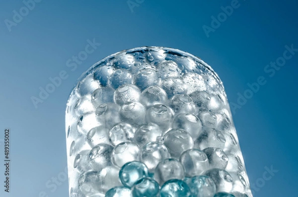 Obraz Hydrogel balls in a glass vase. Hydrogel as an art object or background for a computer desktop. Hydrogel close-up.