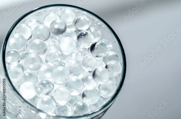 Fototapeta Hydrogel balls in a glass vase. Hydrogel as an art object or background for a computer desktop. Hydrogel close-up.