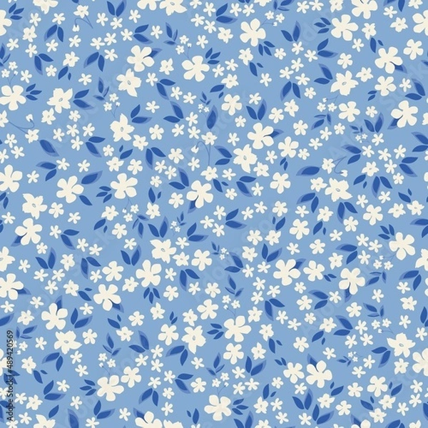 Fototapeta Seamless vintage pattern. Small white flowers and blue leaves. Light blue background. vector texture. fashionable print for textiles, wallpaper and packaging.