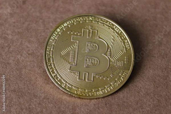Fototapeta Bitcoin coin - golden Bitcoin coins on black mirror surface