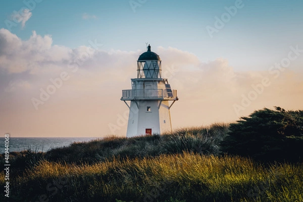 Obraz Lighthouse on the coast at sunset