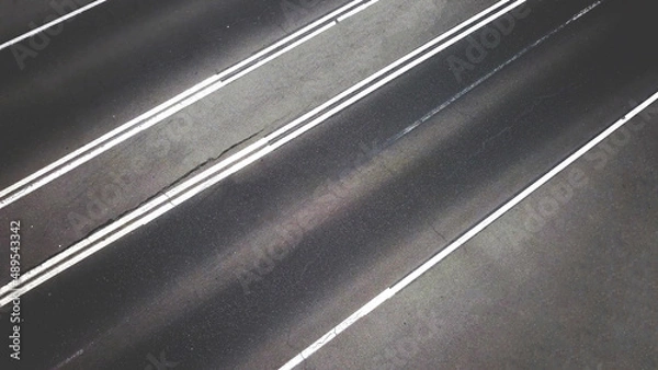 Fototapeta empty asphalt road with lines or stripes from top aerial drone high view background.