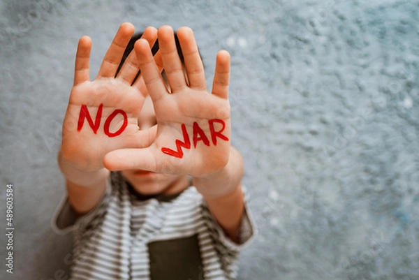 Fototapeta slogan of peace without war is written on the child's hand in red no war.