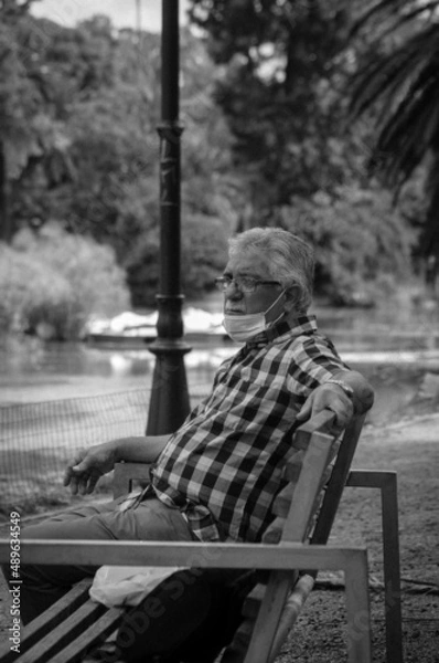Obraz person sitting on a bench