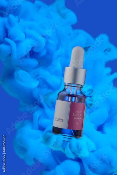 Obraz A bottle of cosmetic liquid on a blue background with clouds.