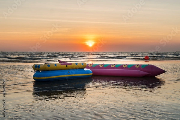 Obraz Banana boat on the beach with sunset background in Thailand.