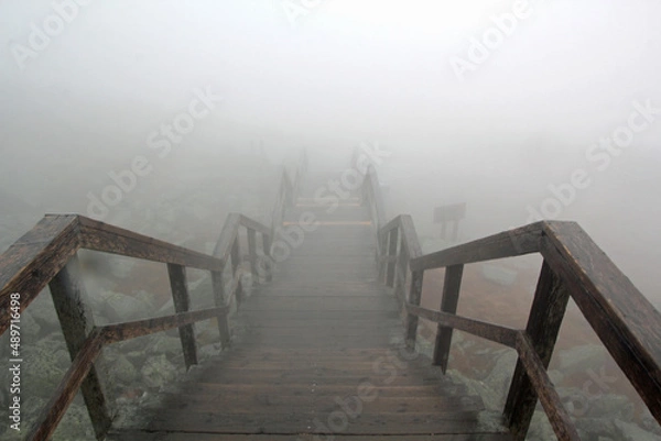 Fototapeta Foggy staircase with railing in high mointains