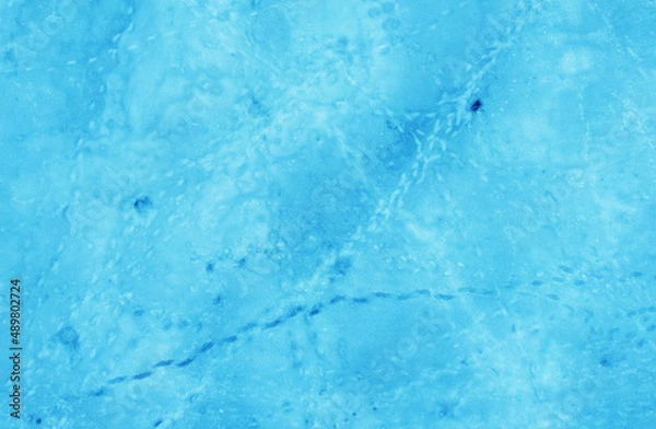 Fototapeta Aerial view of the beautiful blue texture of ice on the surface of the lake in winter