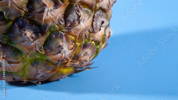 Obraz Pineapple on a blue background. close-up view