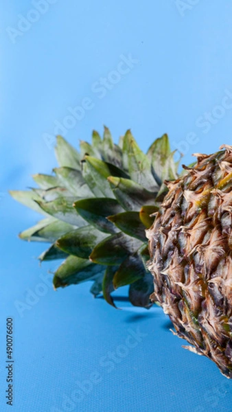 Obraz Pineapple on a blue background. close-up view