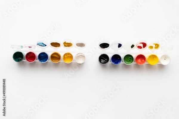 Obraz Flat composition a set of multi-colored paints in jars. Space for the text.