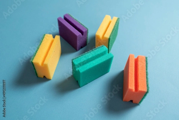 Fototapeta five cleaning sponges of different color flat lay, household concept