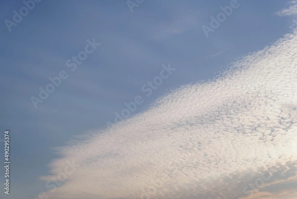 Obraz white clouds clustered in the sky, ray of light, copy space