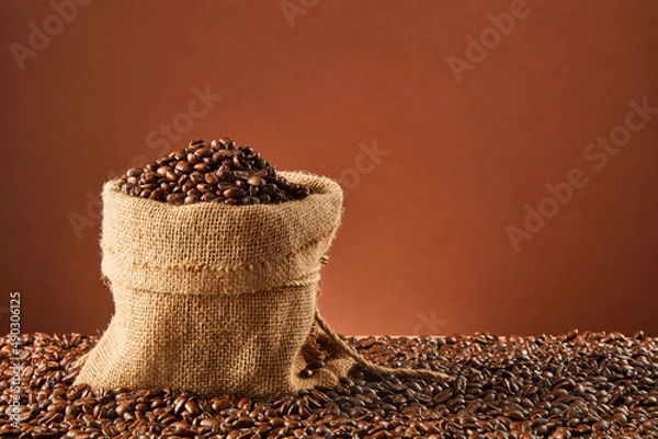Fototapeta Coffee beans and bag on old rusty background