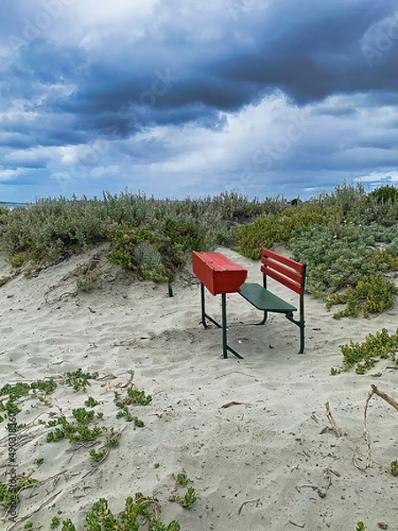 Obraz Remote learning . An isolated desk on a beach.