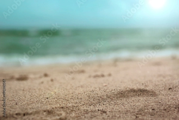 Fototapeta Beach and the foaming waves of the sea are blurry.