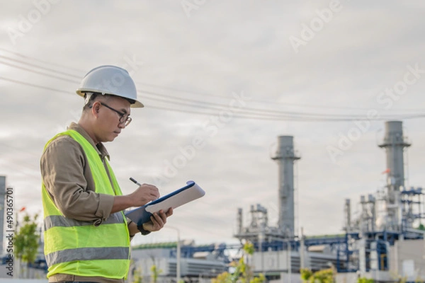 Fototapeta Asian man petrochemical engineer working at oil and gas refinery plant industry factory,The people worker man engineer work control at power plant energy industry manufacturing