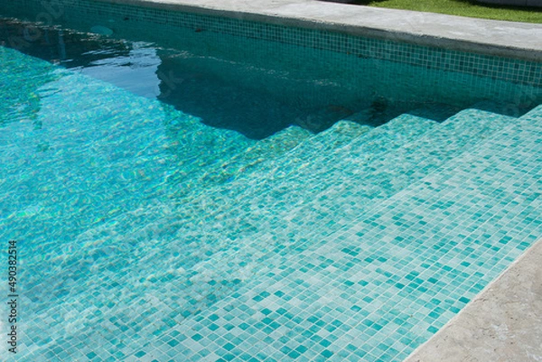 Fototapeta Turquoise swimming pool with no people. Sunny day, Spain