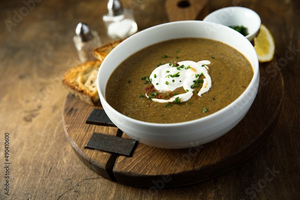 Fototapeta Homemade creamy lentil soup with herbs
