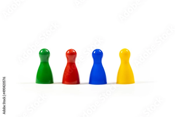Fototapeta Row of 4 different diverse multi colored game pieces representing a diverse group of people, corporate business company teamwork, diversity and togetherness simple metaphor, abstract concept, nobody