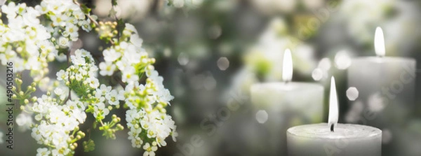 Obraz white flowering branch and 3 white candle lights outside in a garden, floral concept with burning candles decoration for contemplative athmosphere background