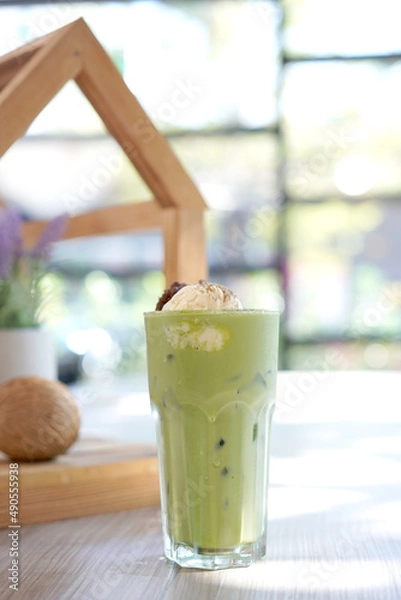 Fototapeta Green tea with milk or latte match with vanilla ice cream in cafe. Fresh and dessert in tall glass.