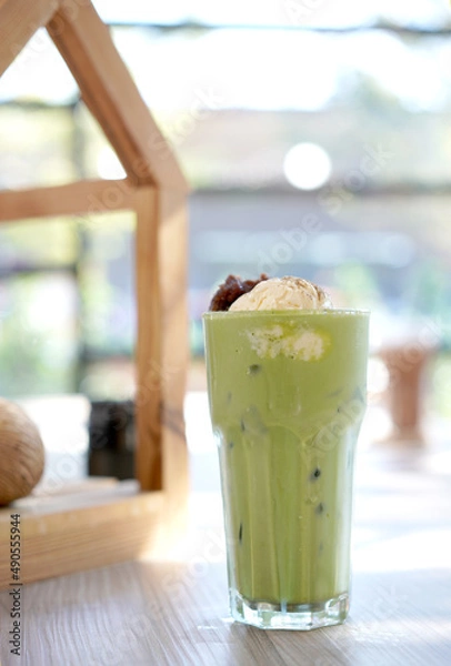 Fototapeta Green tea with milk or latte match with vanilla ice cream in cafe. Fresh and dessert in tall glass.