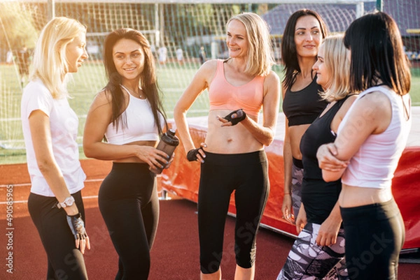 Fototapeta Group Of Six Female Friends smiling and chating Outdoor at stadium