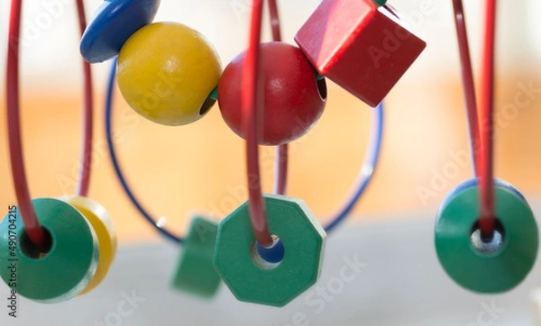 Fototapeta circle Bead Maze three green polygons and a sphere - a toy for children - blurred background