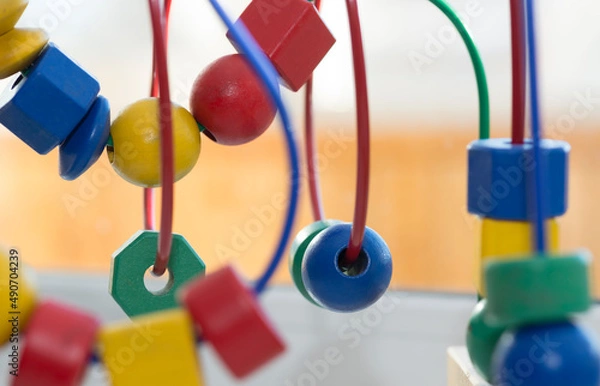 Fototapeta colored blocks on a spiral - circle Bead Maze - educational toy for children, background in the theme of child development