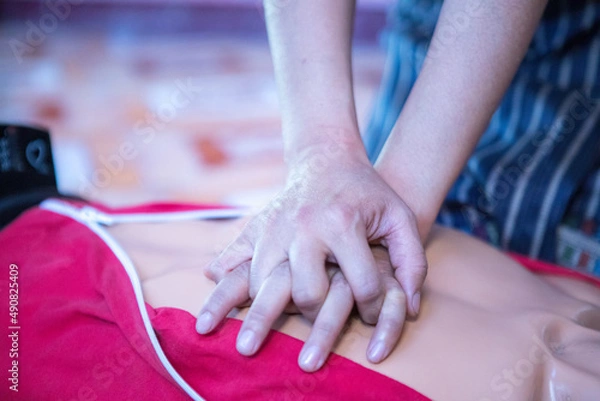 Obraz first aid traning for emergency with heart shock of the resuscitation process, momen is trying cpr of the heart attacks