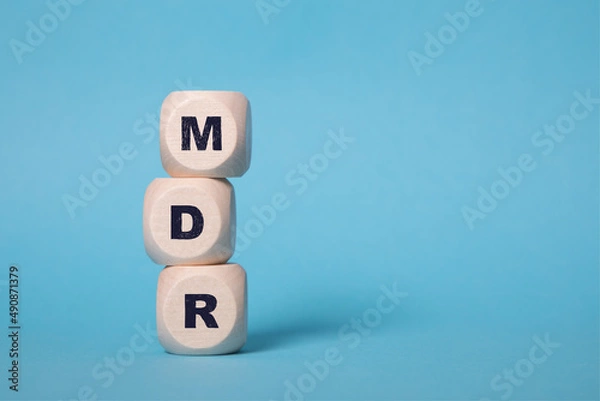 Obraz MDR Acronym on wooden blocks isolated on bluebackground, copy space.